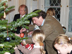 Landeshauptmann Mag. Franz Voves schmückt mit den Kindern den Weihnachtsbaum im Weißen Saal der Grazer Burg.  